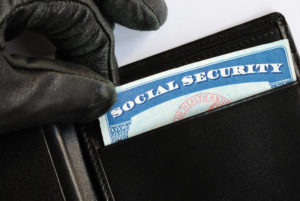 A thief stealing a social security card.