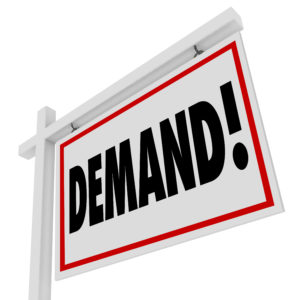 Real estate sign that says Demand! to illustrate the shortage of home inventory.