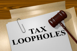 A stack of paper labeled Tax Loopholes.